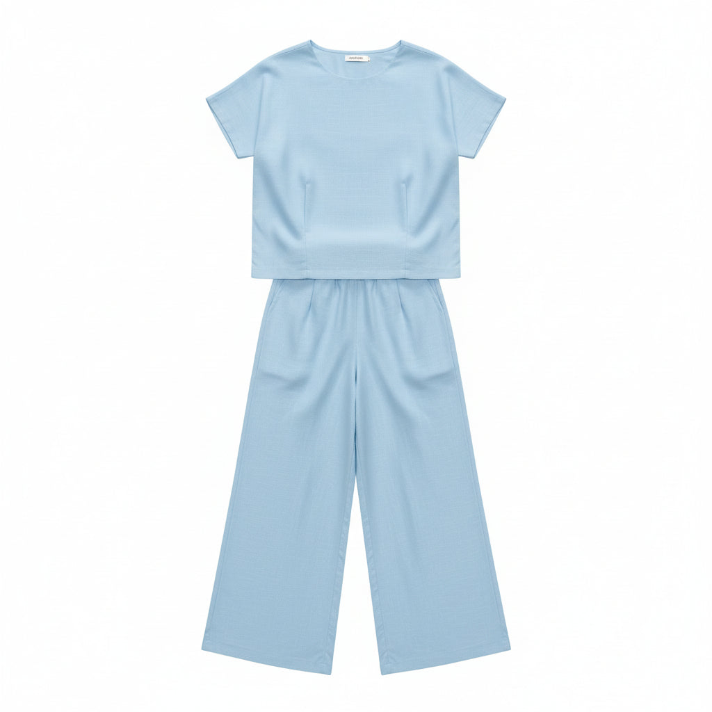 Person wearing a light blue outfit holding a straw bag in a store setting.