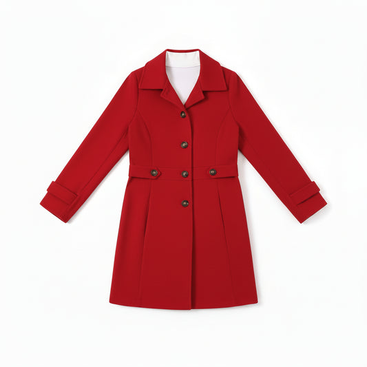 Woman wearing a red coat holding a coffee cup indoors.