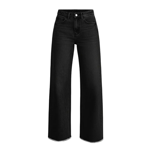 Person wearing black wide-leg jeans on a plain background