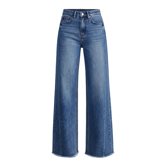 Person wearing blue jeans on a plain background