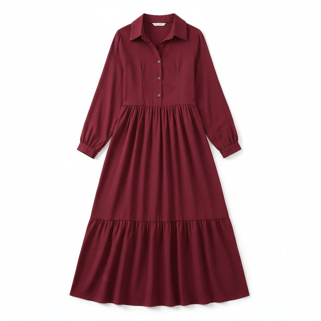 Woman wearing a burgundy dress with long sleeves in a room.