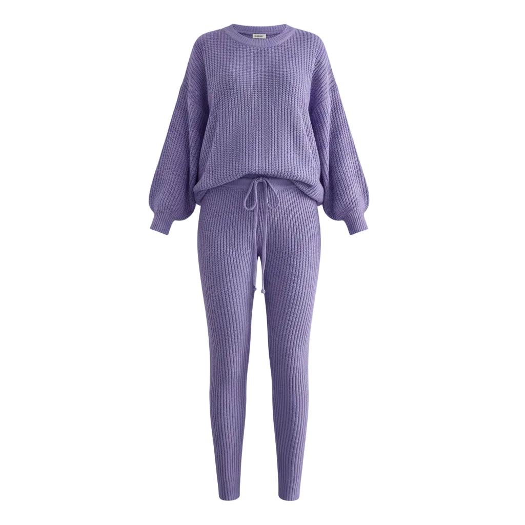 Person wearing a purple knit outfit in a living room setting.