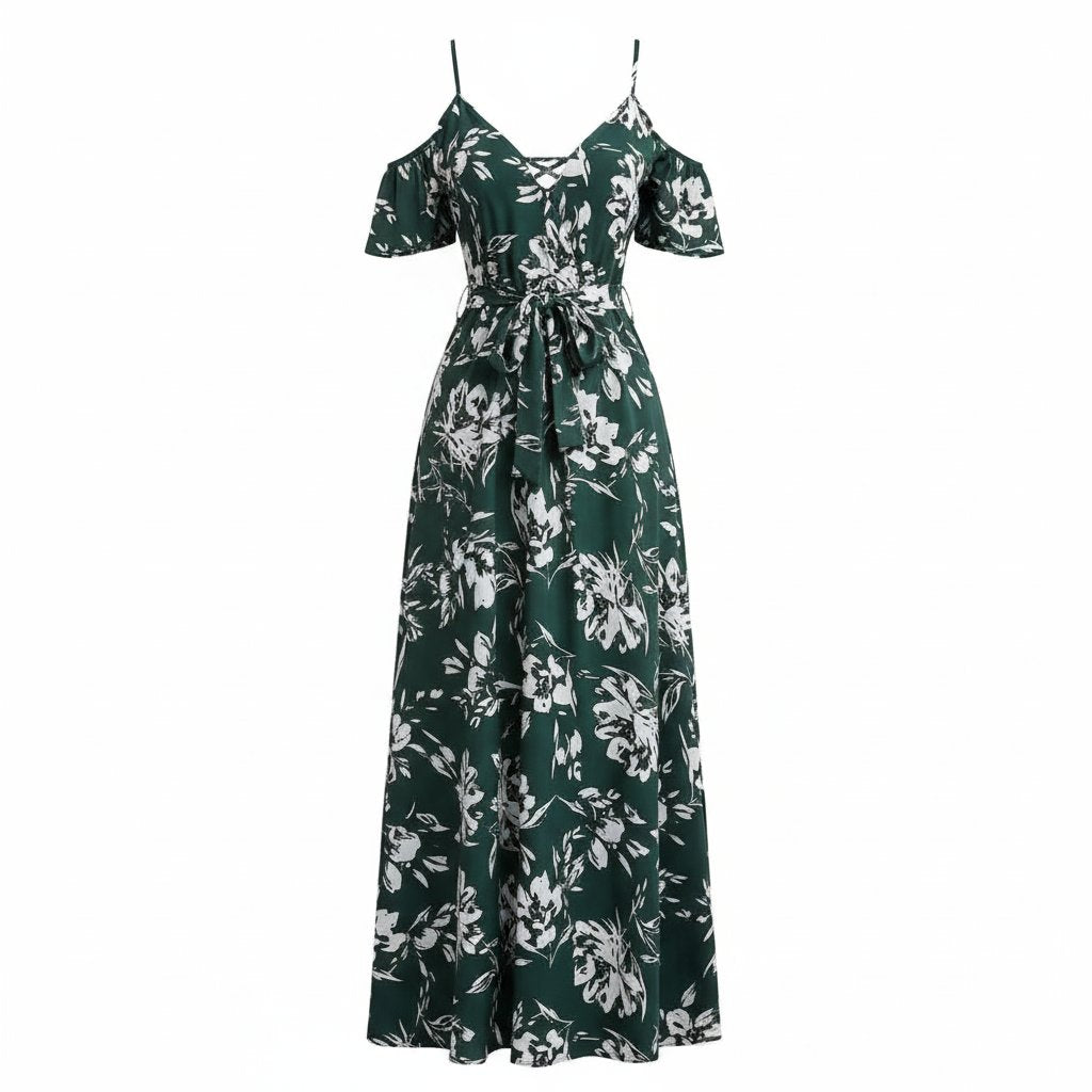 Woman wearing a green floral dress sitting on a wicker chair.