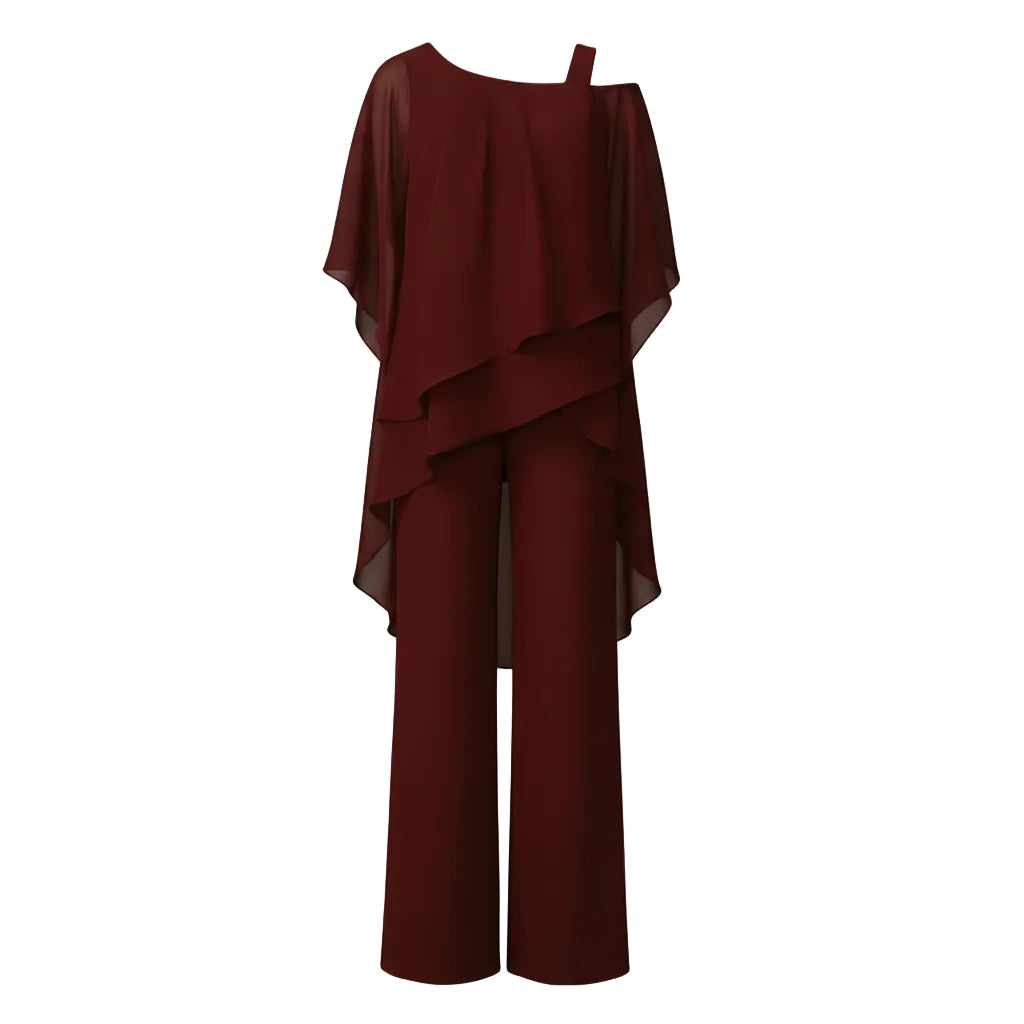 Woman wearing a burgundy outfit standing in an indoor setting.