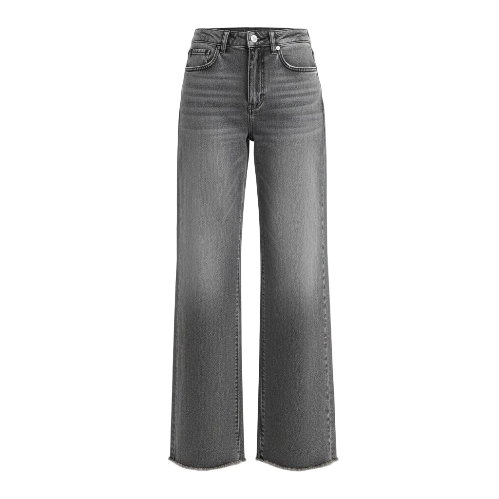 Person wearing gray flared jeans on a plain background