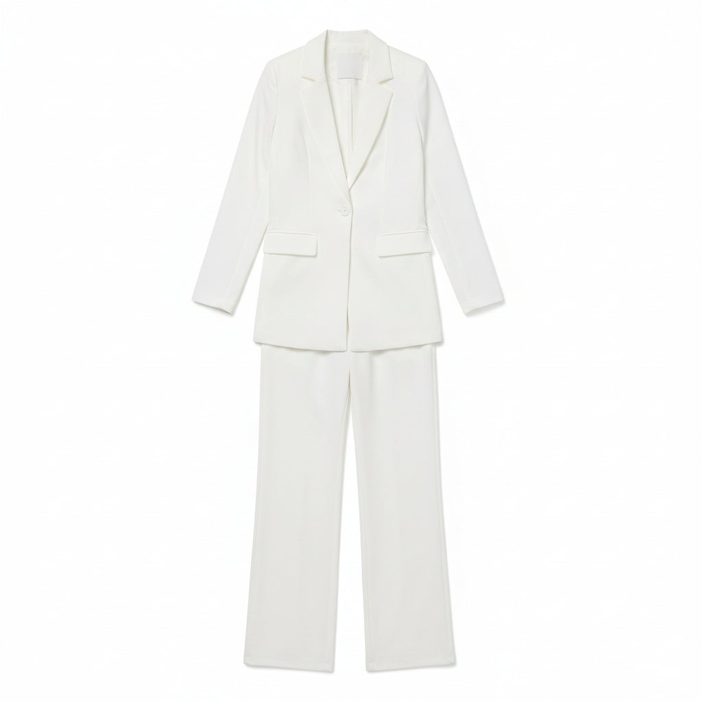 Person wearing a white suit against a plain background
