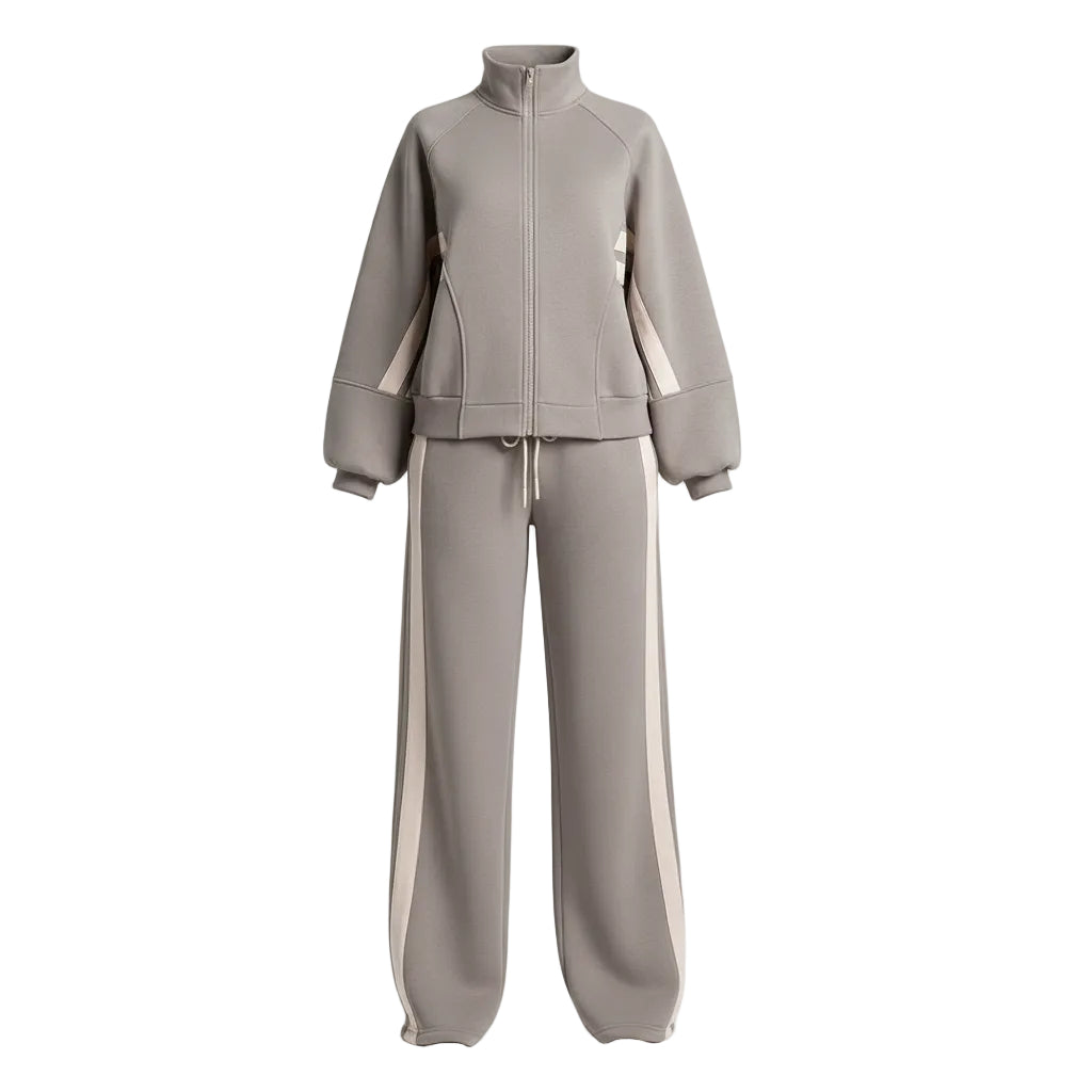 Person wearing a gray tracksuit with white stripes in an indoor setting.