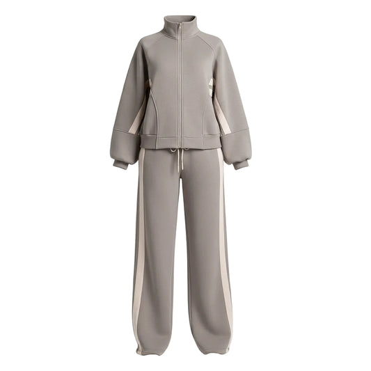 Person wearing a gray tracksuit with white stripes in an indoor setting.