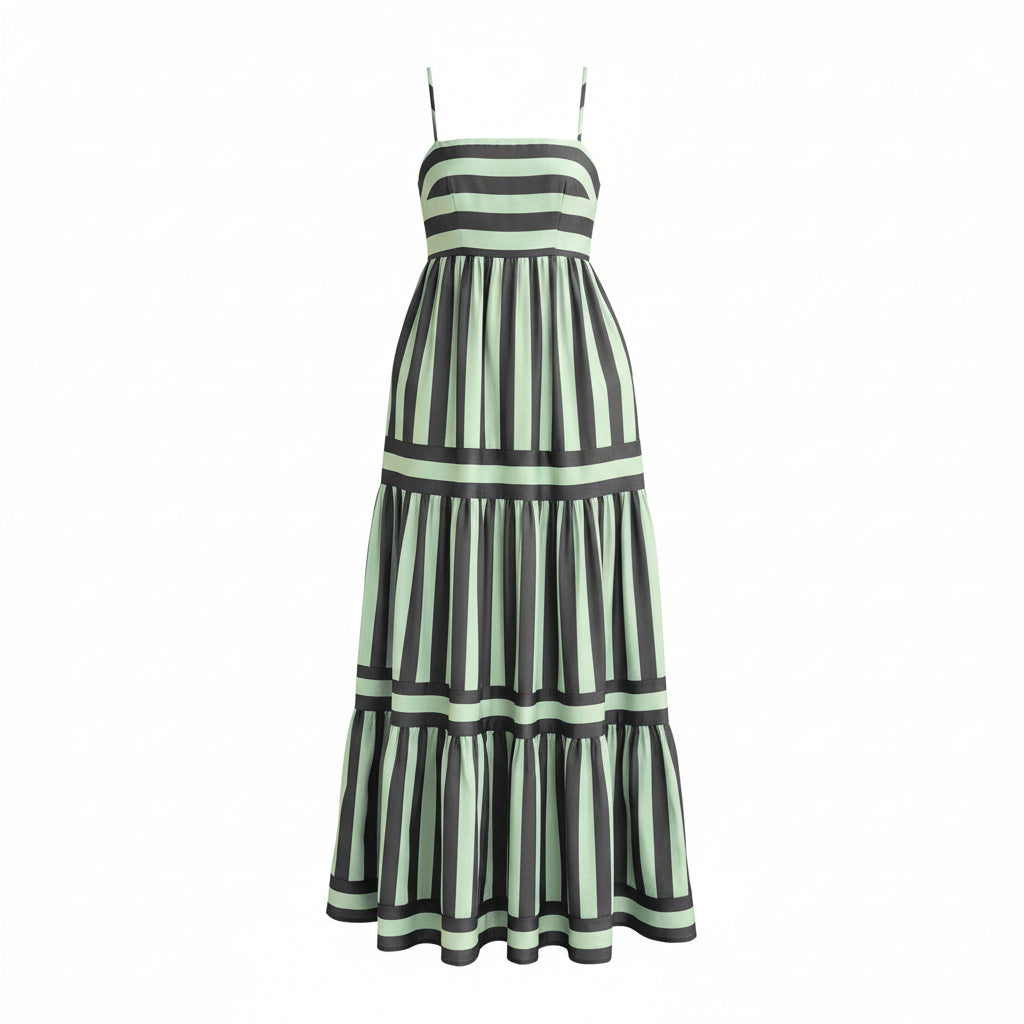 Woman wearing a green and black striped dress with a vase of sunflowers in the background.