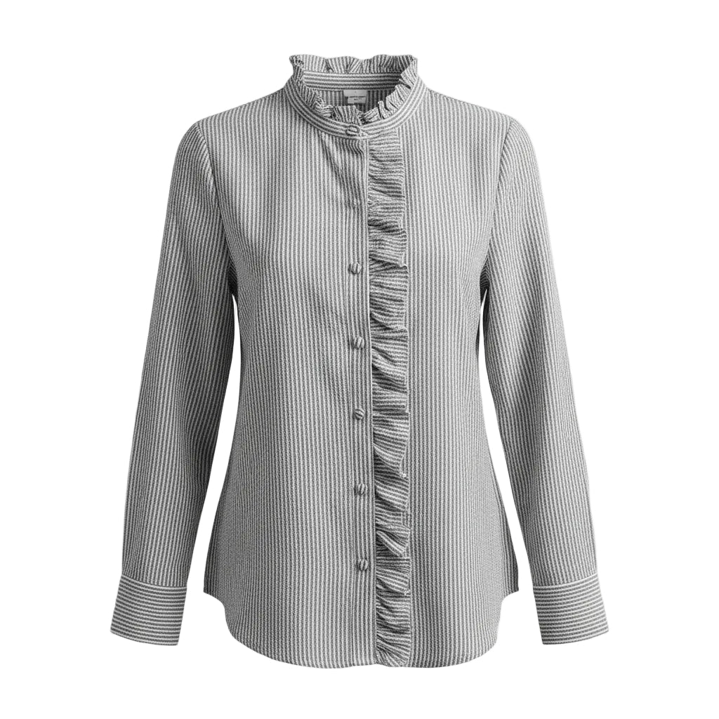 Woman wearing a gray striped shirt with ruffle details in a living room setting.