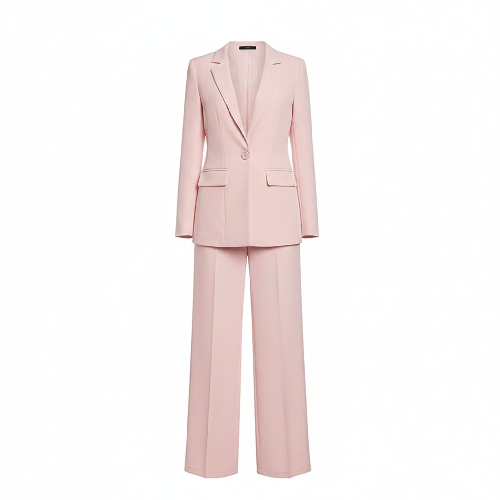 Person wearing a light pink suit against a plain background