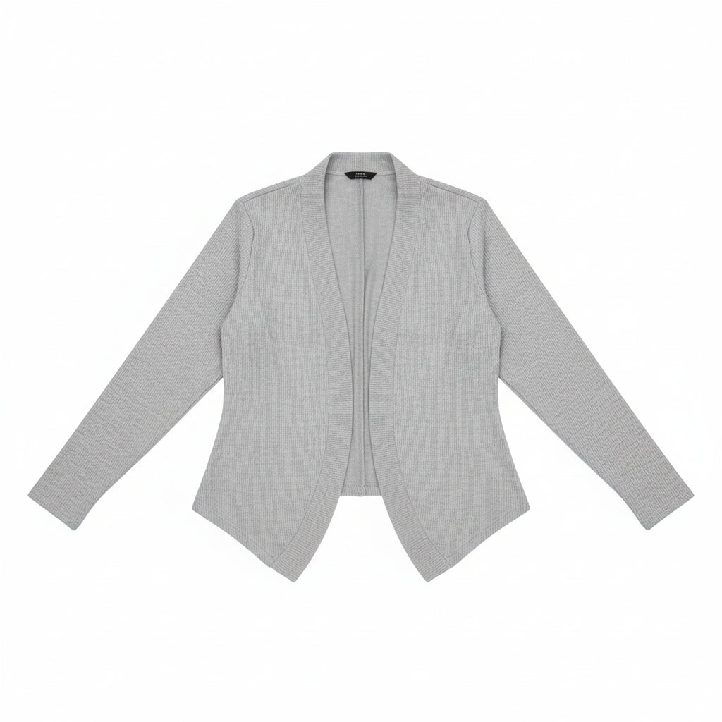 Woman taking a selfie in a gray blazer and white top.